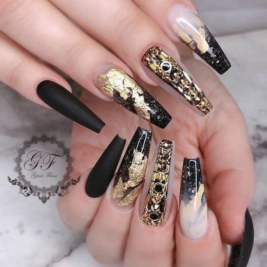 nails decorated with black and gold